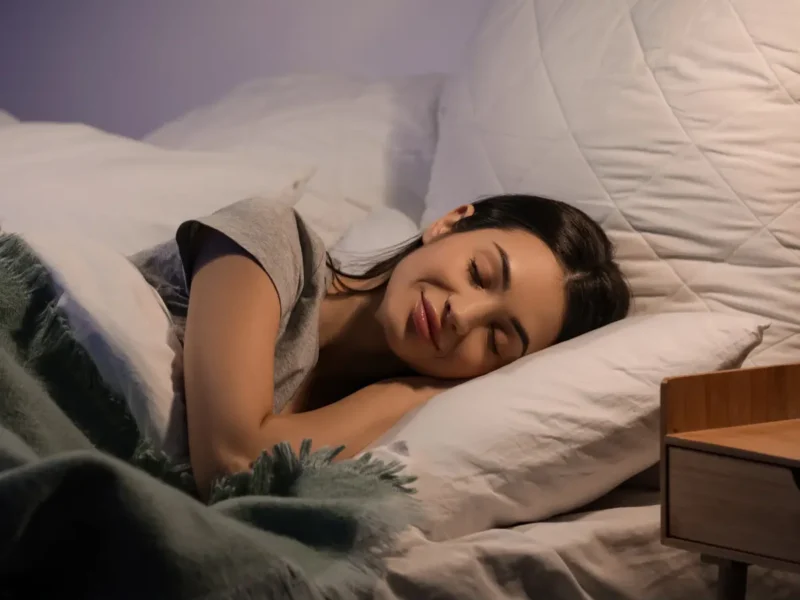 Woman Sleeping woman sleeping comfortably on her side in bed